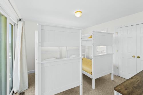 a white bunk bed in a white room at Sound Happy in Rodanthe