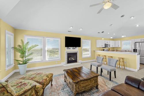 a living room with a couch and a table at Sound Happy in Rodanthe