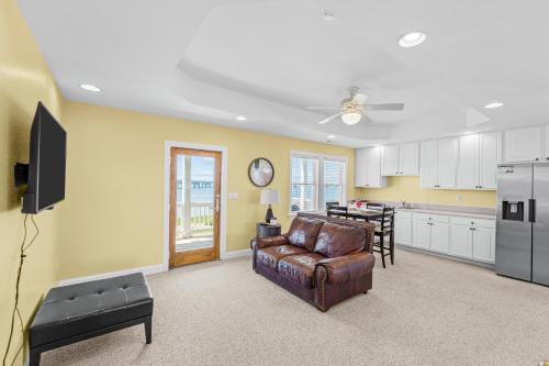 a living room with a couch and a kitchen at Sound Happy in Rodanthe