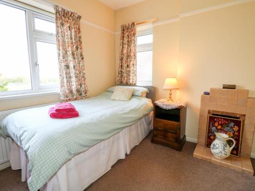 a bedroom with a bed and a fireplace at The Old Grocery in Hollingwood