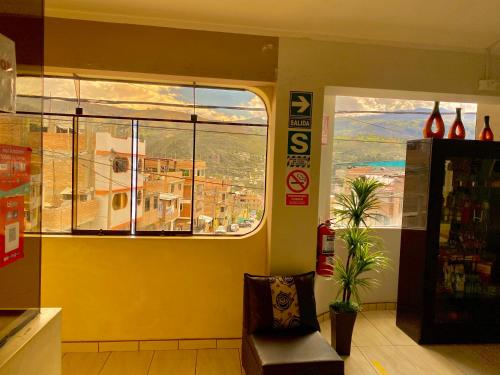 a room with a window with a view of a city at HOSPEDAJE ILLARY in Huaraz