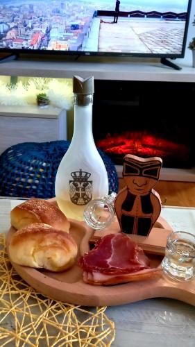 a table with a bottle and a plate of food at Sweet Dreams SPA in Zlatibor