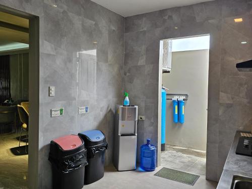 a room with a refrigerator and two trash cans at Spacious 5-bedroom, 4-bath townhouse in Legazpi City in Legazpi