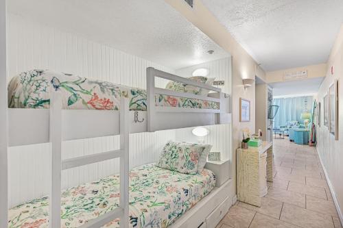 a bedroom with two bunk beds and a hallway at Pelican Beach Resort Rentals in Destin
