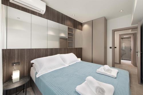 a bedroom with a bed with towels on it at 30 Senses Luxury Apartment Insight in Ialysos