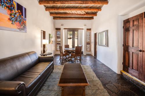 a living room with a couch and a table at La Posada De Santa Fe, a Tribute Portfolio Resort & Spa in Santa Fe