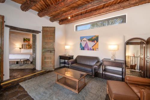 a living room with a couch and a table at La Posada De Santa Fe, a Tribute Portfolio Resort & Spa in Santa Fe