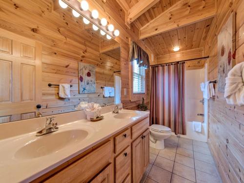 a bathroom with a sink and a toilet in a room at Misty Mountain Hideaway, 3 Bedrooms, Sleeps 10, Pool Access, WiFi in Pigeon Forge