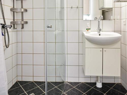 a bathroom with a sink and a shower at Holiday home Nexø XLI in Neksø