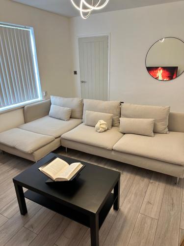 a living room with a couch and a coffee table at The Maison- Cozy home stay in Nottingham