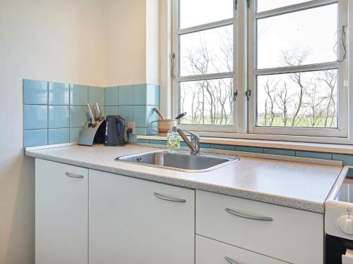 une cuisine avec un évier et une fenêtre dans l'établissement Holiday home Aakirkeby XLV, à Åkirkeby