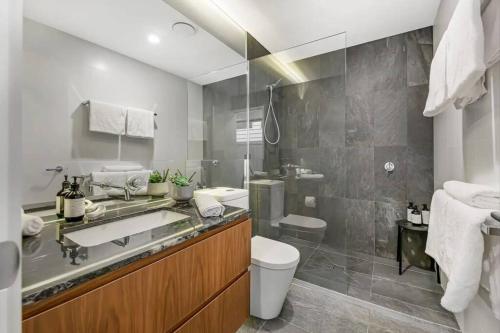 a bathroom with a sink and a toilet at Serenity in Central Maleny in Maleny