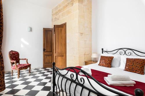 a bedroom with a black and white checkered floor at Traditional & Modern Maltese Townhouse - Rooftop Terrace and Sea Views, close to Birgu Waterfront in Cospicua