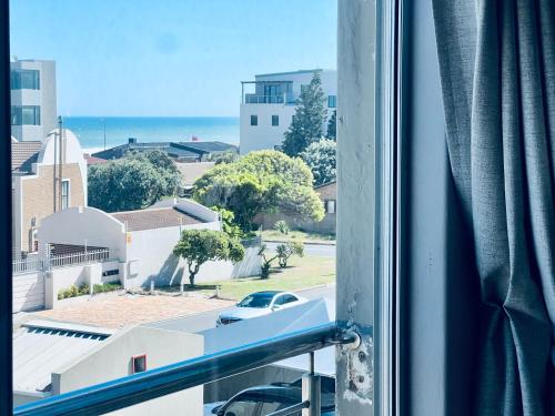 a window with a view of a street at Caline Vip Apartments, beach close in Bloubergstrand