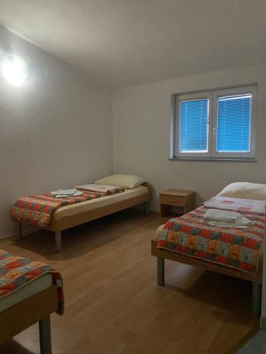 a room with two beds and a window at Maća i Ante Pavlović in Međugorje