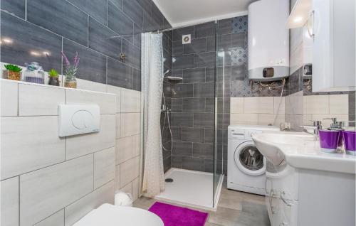 a bathroom with a toilet and a sink and a washing machine at Beautiful Apartment In Stara Baska With Wifi in Stara Baška