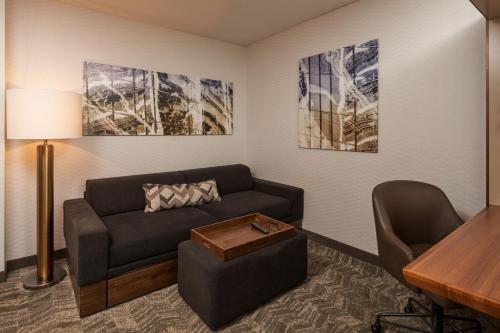 a living room with a couch and a table at SpringHill Suites by Marriott Philadelphia Airport / Ridley Park in Ridley Park