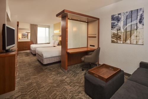 a hotel room with two beds and a desk at SpringHill Suites by Marriott Philadelphia Airport / Ridley Park in Ridley Park