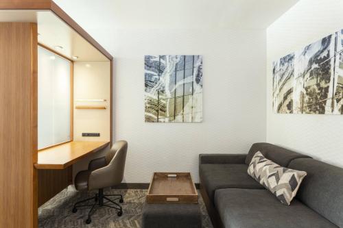 a living room with a couch and a desk at SpringHill Suites by Marriott Philadelphia Airport / Ridley Park in Ridley Park