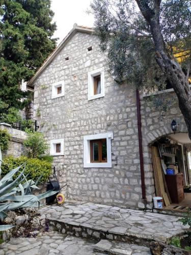a stone house with a stone walkway in front of it at Villa Golda, The whole house Biker Friendly in Rijeka Reževići