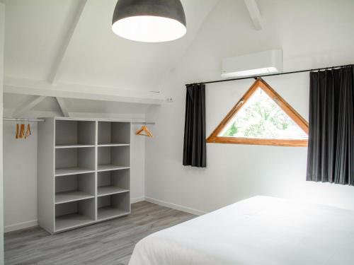 a bedroom with a bed and a window at Lac Bleu 16 in Lacapelle-Marival
