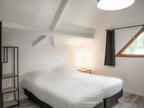 a bedroom with a white bed and a window at Lac Bleu 40 in Lacapelle-Marival