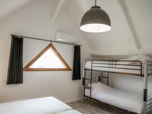 a bedroom with two bunk beds and a window at Lac Bleu 40 in Lacapelle-Marival