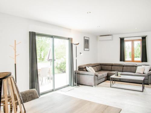 a living room with a couch and a table at Lac Bleu 39 en 40 combi in Lacapelle-Marival
