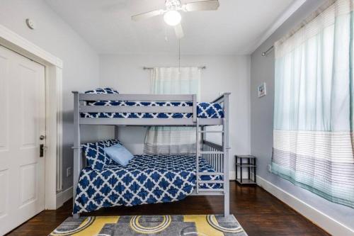 a bedroom with two bunk beds and a window at Cozy sea breeze bungalow - 2 mins to the beach in Galveston
