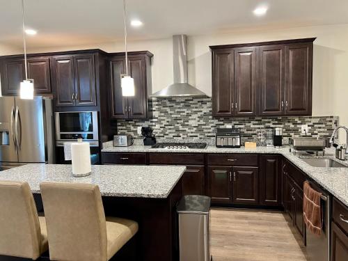 a kitchen with wooden cabinets and a counter top at Apple House- New Townhouse - 2 Car Garage by CCBC & Franklin Sq in Rosedale