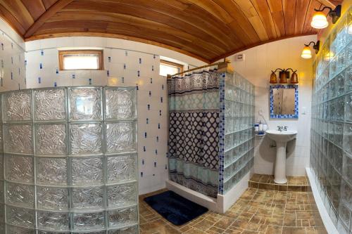 a bathroom with a shower and a sink and a toilet at casa munay in Canoa