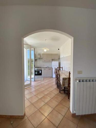 a kitchen and dining room with an archway in a house at il PERO in Camporosso