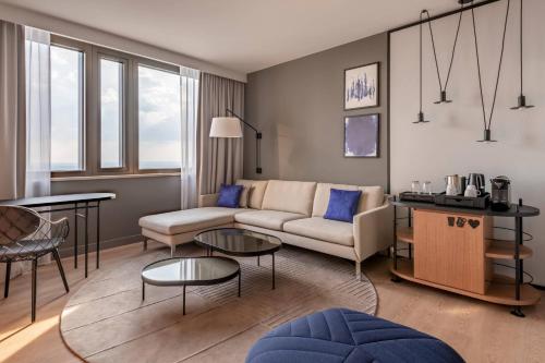a living room with a couch and a table at Frankfurt Marriott Hotel in Frankfurt/Main