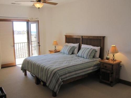 a bedroom with a bed with two lamps and a window at Beach themed La Ventana Del Mar Home with in-house WiFi in San Felipe