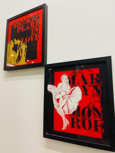 two framed posters of a man on a wall at Pioneiro Hotel in Teixeira de Freitas