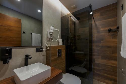 a bathroom with a sink and a shower and a toilet at Lakeside in Zlatibor