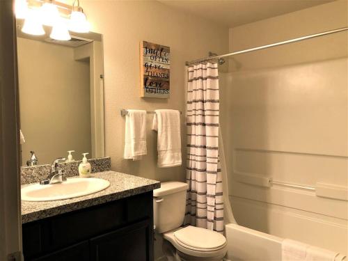 a bathroom with a sink and a toilet and a shower at Granite Apartment - Prescott Cabin Rentals in Prescott