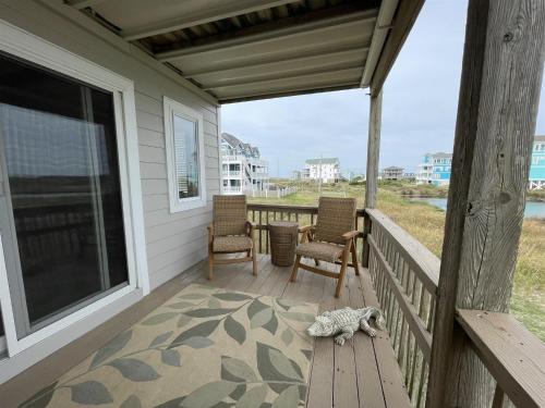 a cat laying on the porch of a house at SW 1 STARFISH condo in Hatteras