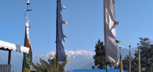 a group of flags in front of a mountain at The Bliss Homestay in Gangtok