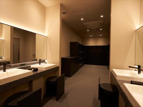 a bathroom with two sinks and a large mirror at CROSS Life Hakata Tenjin in Fukuoka