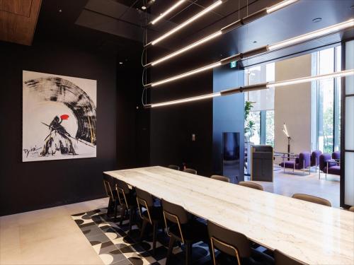 a conference room with a large wooden table and chairs at CROSS Life Hakata Tenjin in Fukuoka