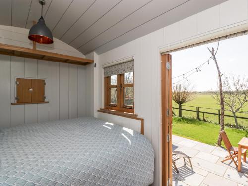 a bedroom with a bed and a window at Little Hut in Weston-super-Mare