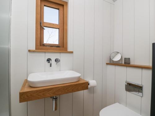 a bathroom with a sink and a toilet at Little Hut in Weston-super-Mare