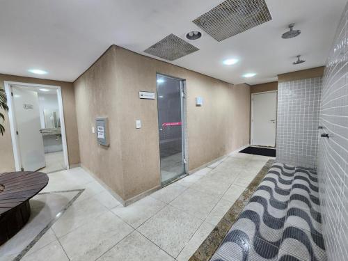 a large room with a shower and a glass door at AP Alecrim Porto Real Suítes com Tela de Proteção Praia Privativa in Mangaratiba