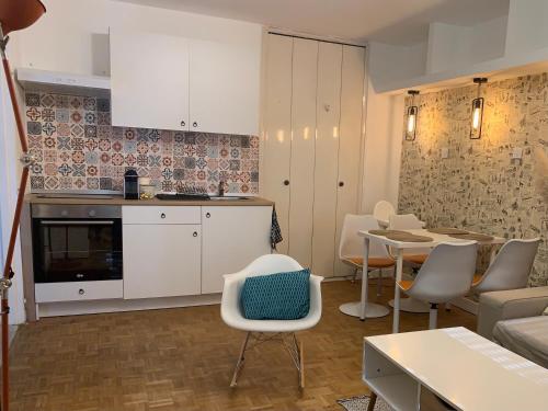 une cuisine et un salon avec une table et des chaises dans l'établissement Cosy pretty flat, à Saint-Étienne