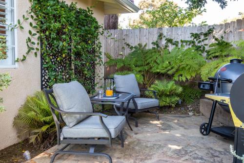 a patio with two chairs and a table and a grill at FIFA PRIME-Pvt Luxe Home! King Bed, Jacuzzi, Fire Pit, BBQ! Beautiful! in Los Angeles