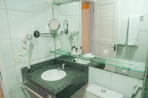 a bathroom with a sink and a mirror at Hotel VillaOeste in Mossoró