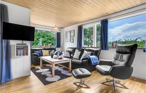 a living room with leather furniture and a flat screen tv at Holiday Home Hejls 28 in Hejls