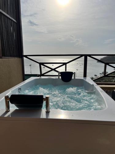 a bath tub with a view of the ocean at Cabañas Paraiso in Taganga