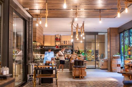 a man is standing in the kitchen of a store at Hotel Indigo Phuket Patong by IHG in Patong Beach